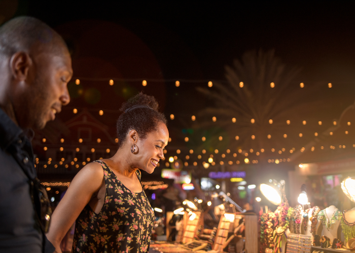 Man And Woman Smiling As They Shop For Souvenirs 