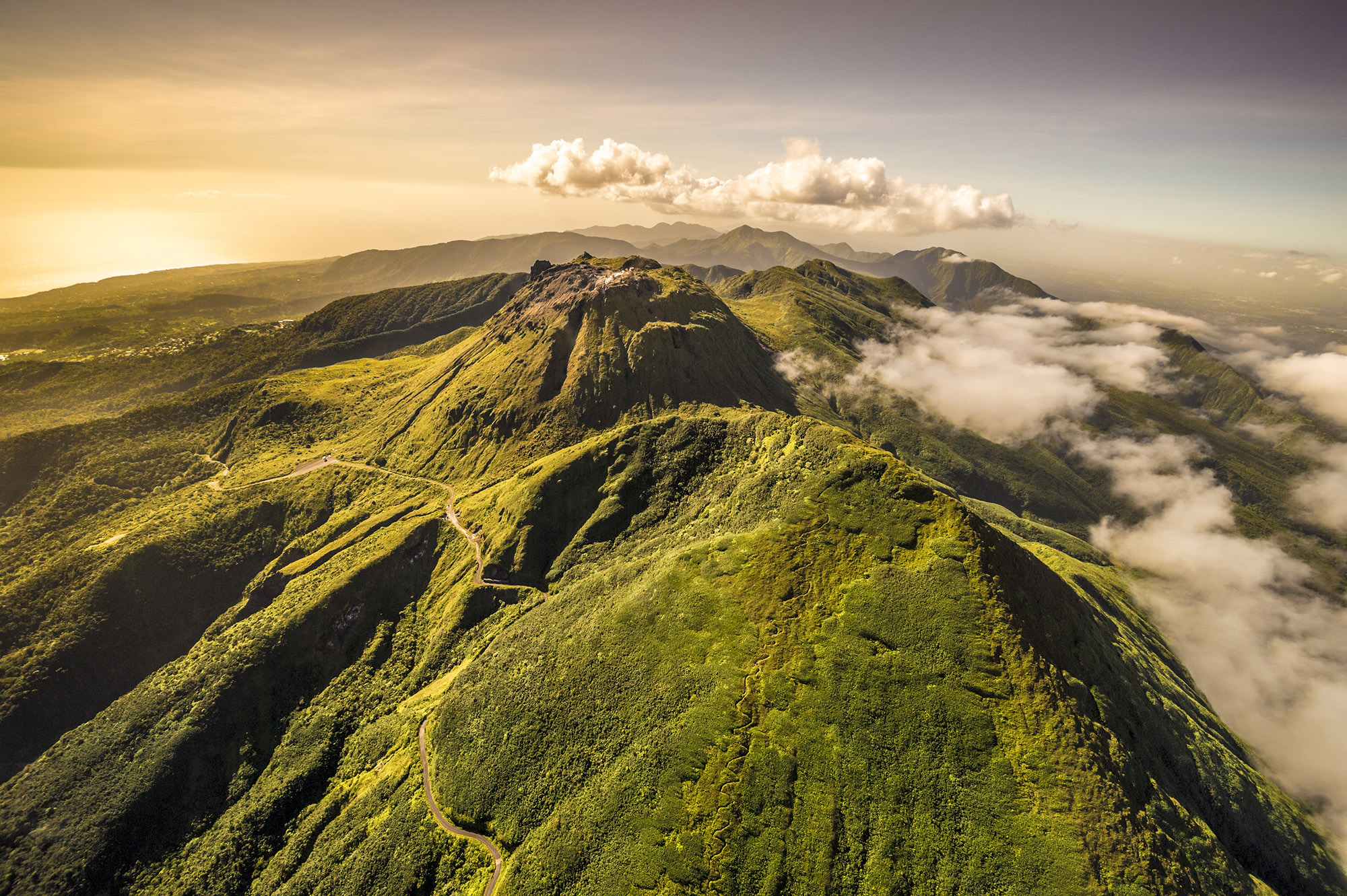 Aerial view of clouds surrounding the peak of a La Soufrière volcano