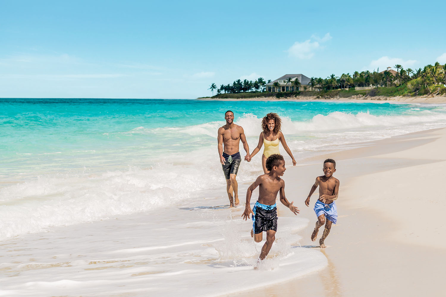 Family walking along a tropical beach in Nassau