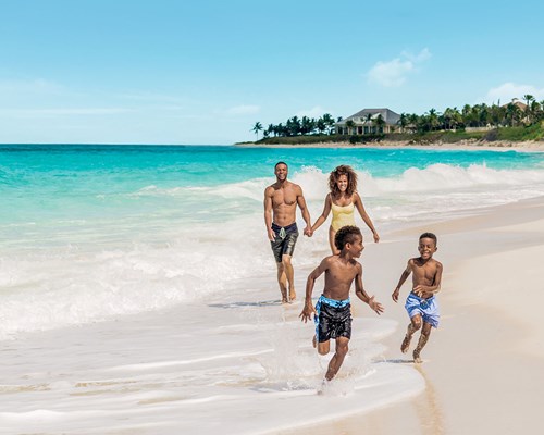 Family walking along a tropical beach in Nassau