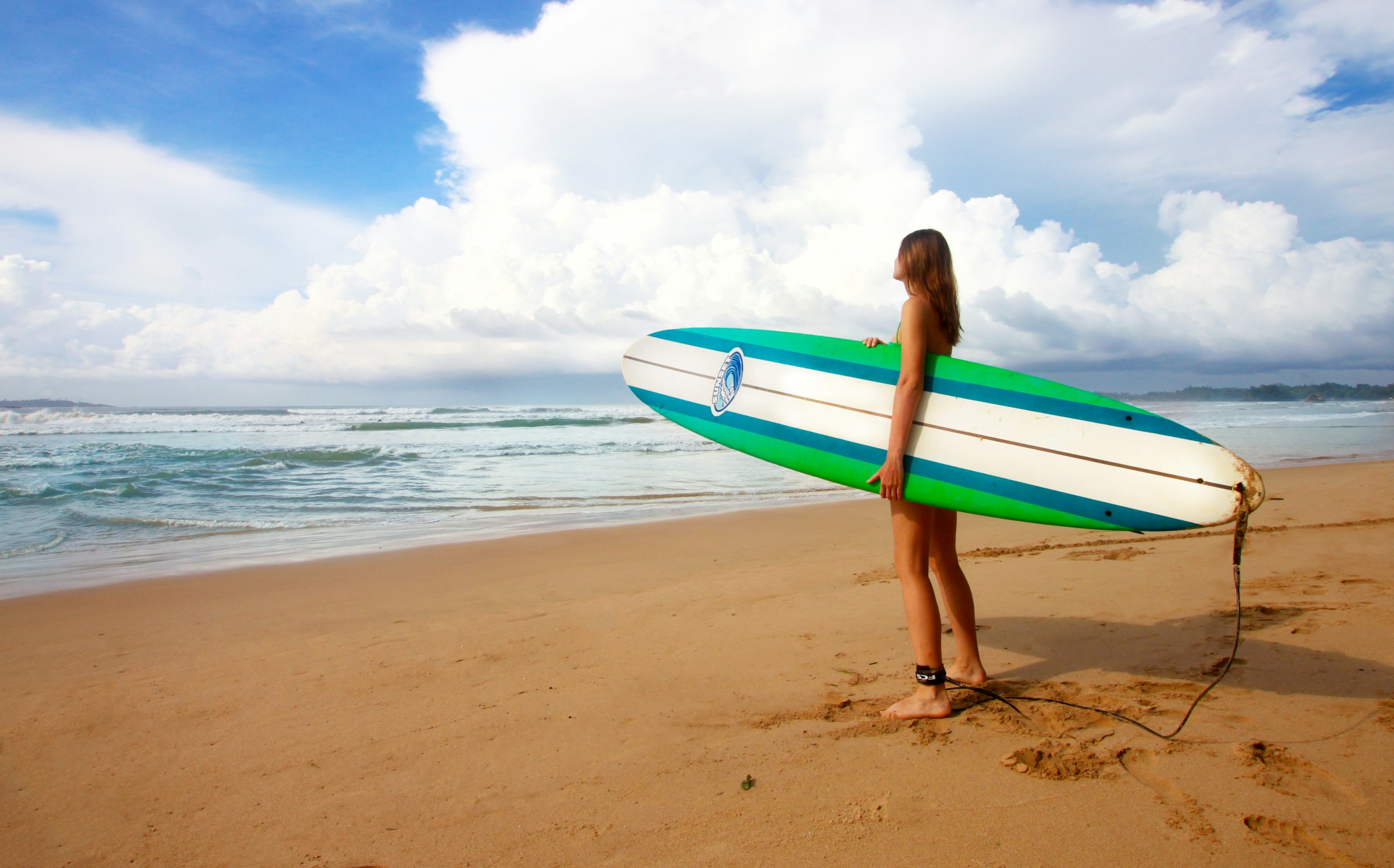 A female surfboarder on Weligama Beach