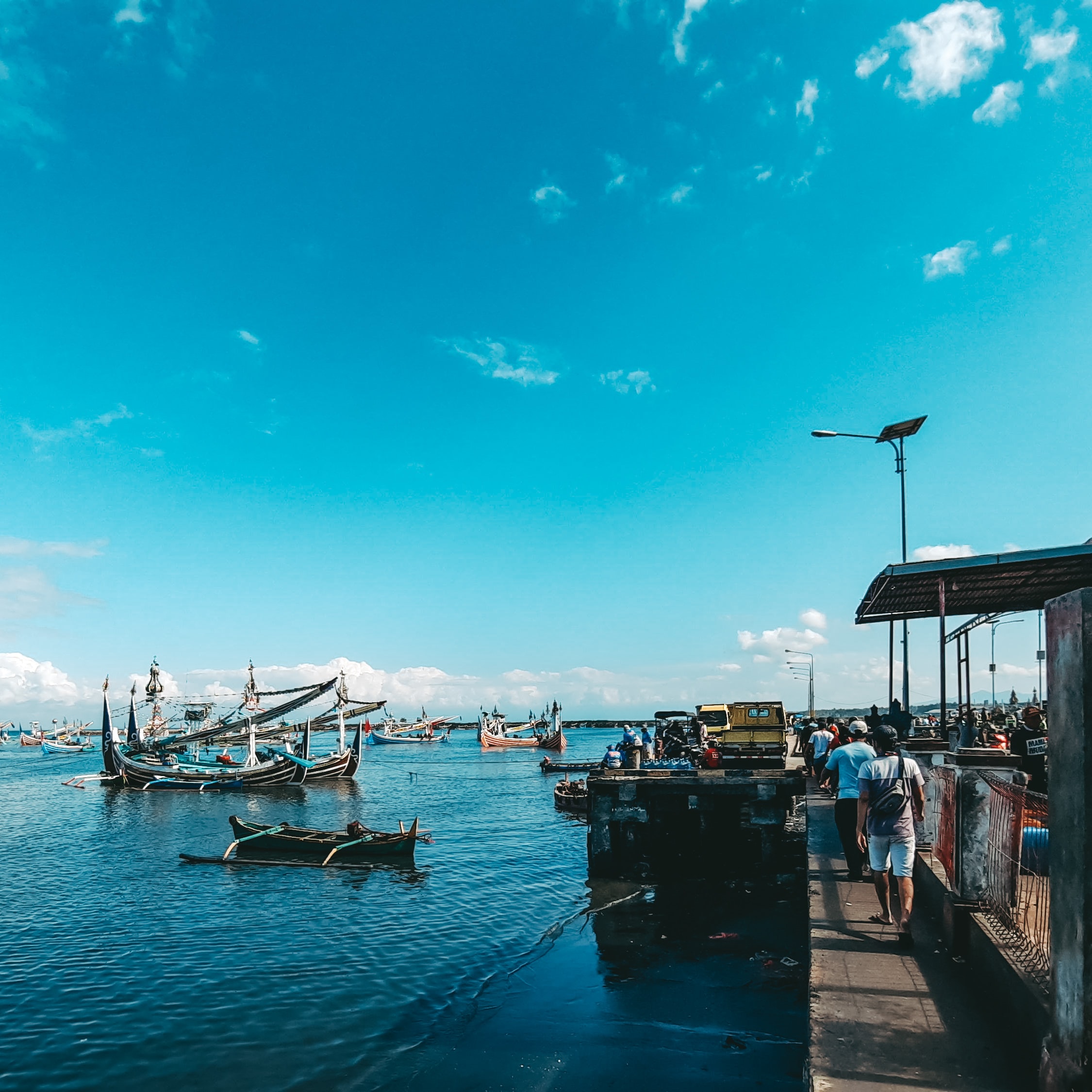 Traditional Balinese dock with boats and fishermen