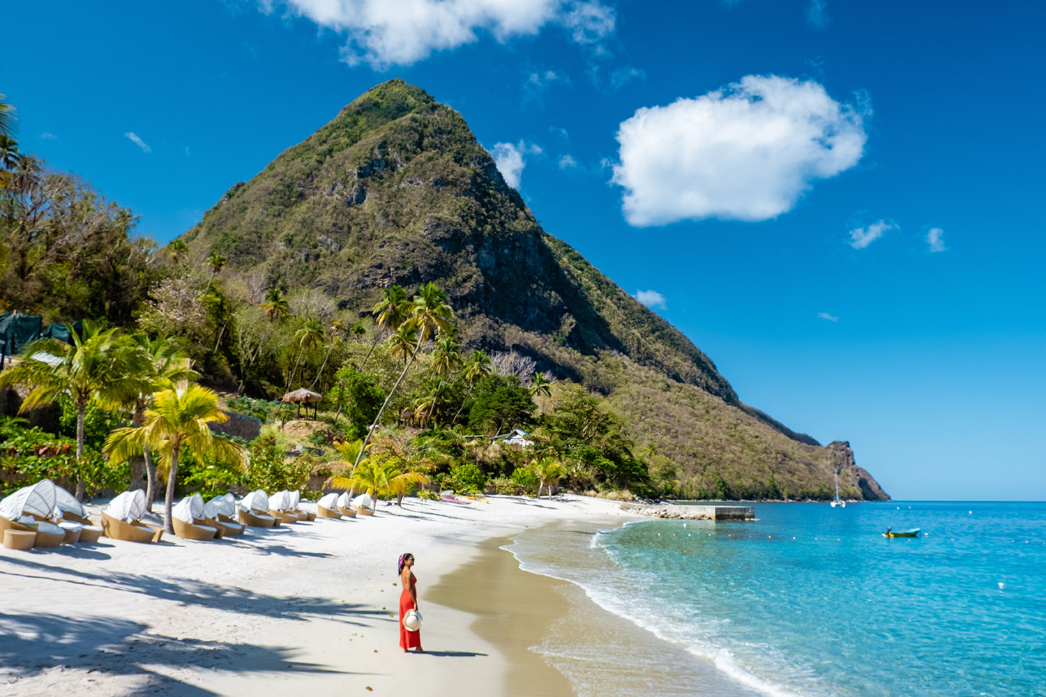 Woman walking on the beach with red dress in St Lucia
