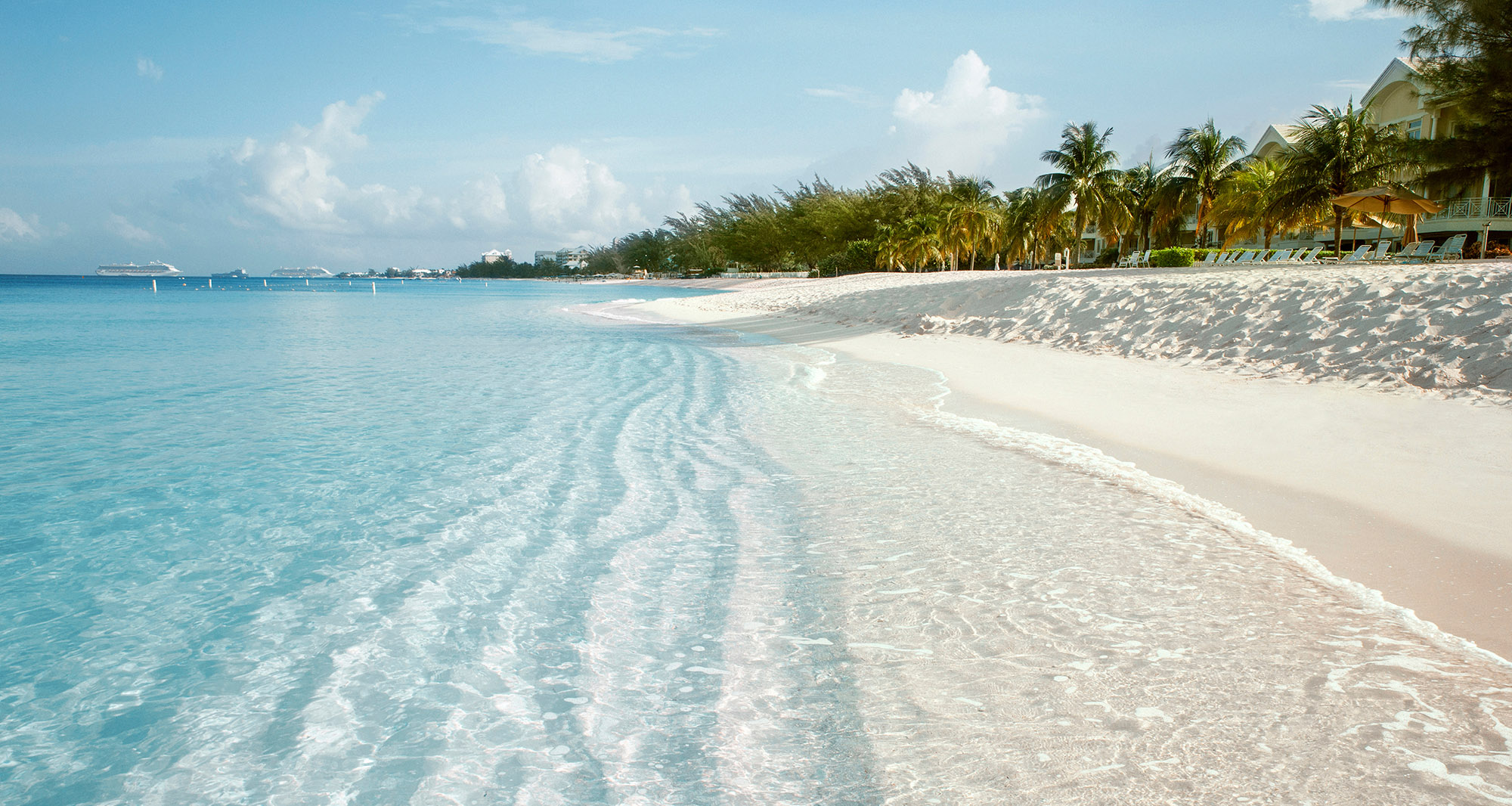 A stretch of white sand tropical beach with clear calm sea - Seven Mile Beach