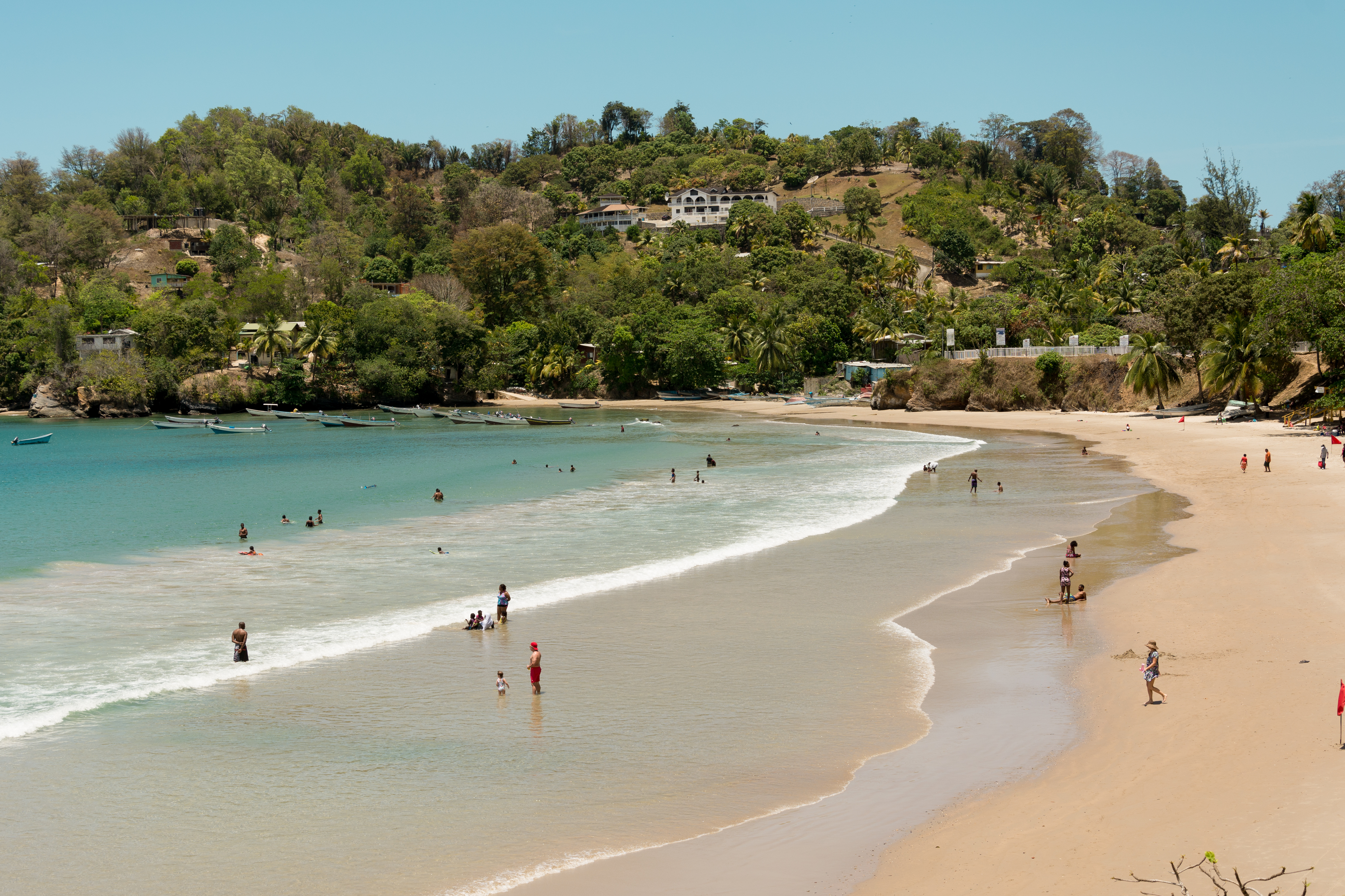  People relaxing on a golden sand tropical beach