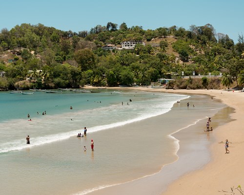 People relaxing on a golden sand tropical beach