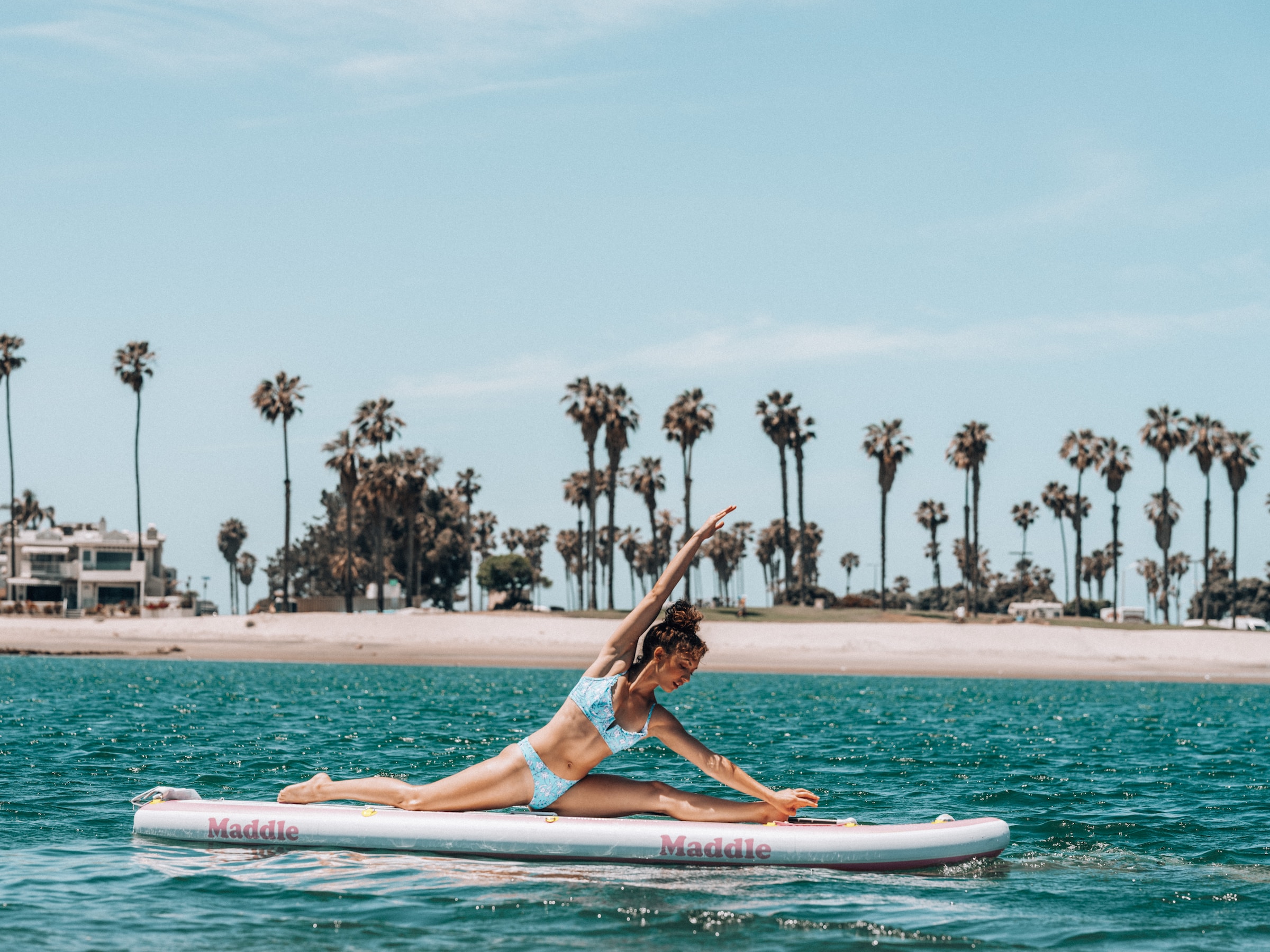 A woman stretching on a paddleboard