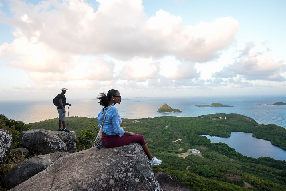 A couple standing at the Welcome Stone at Levera Park