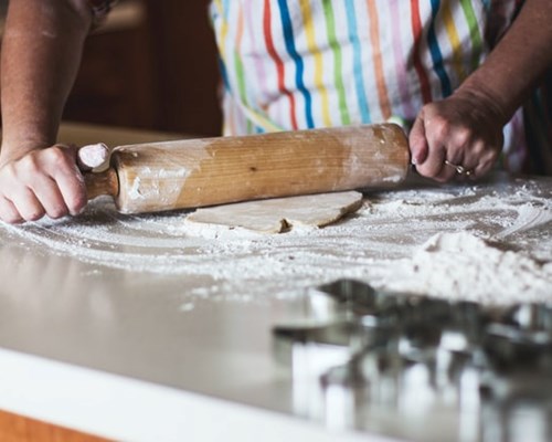 Person Rolling Out Dough