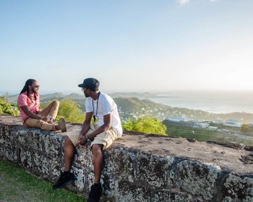 2 men sitting on a wall at Fort Frederick in Grenada