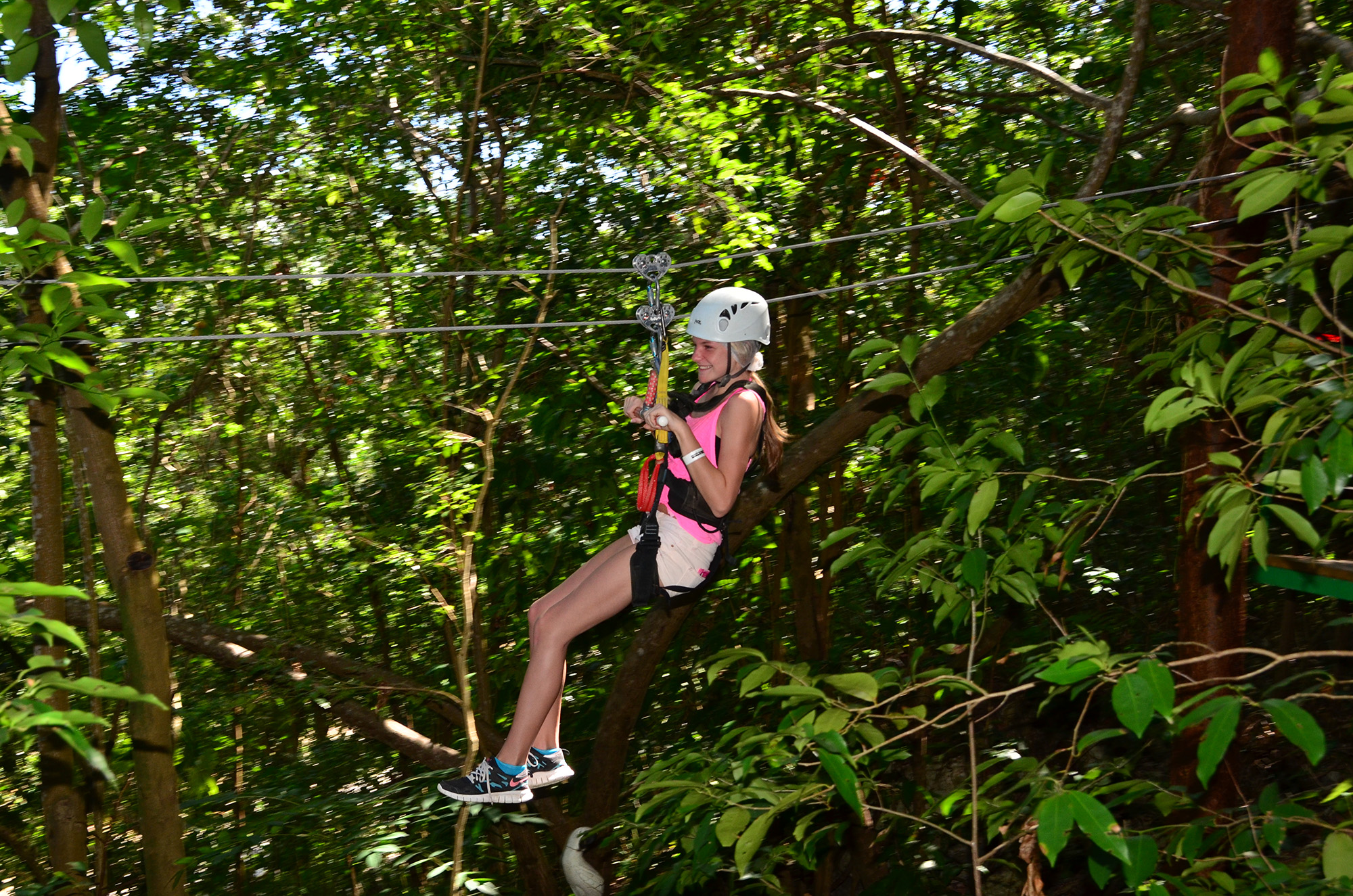 Girl on a zip-line through the jungle