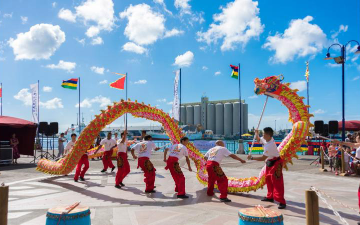 Performers with a large model of a red and yellow Chinese dragon