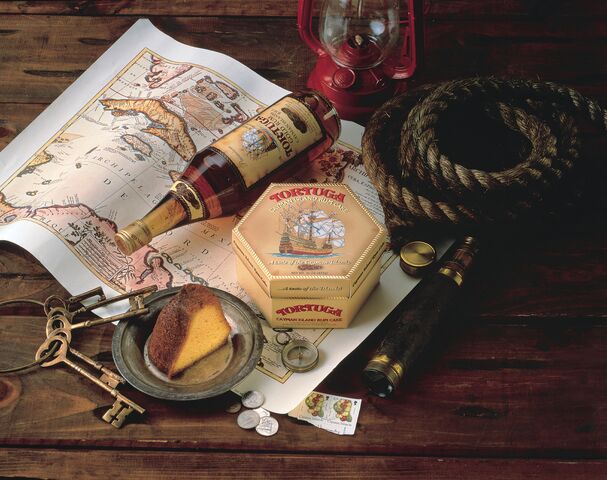 Rum bottle on top of map and rope 