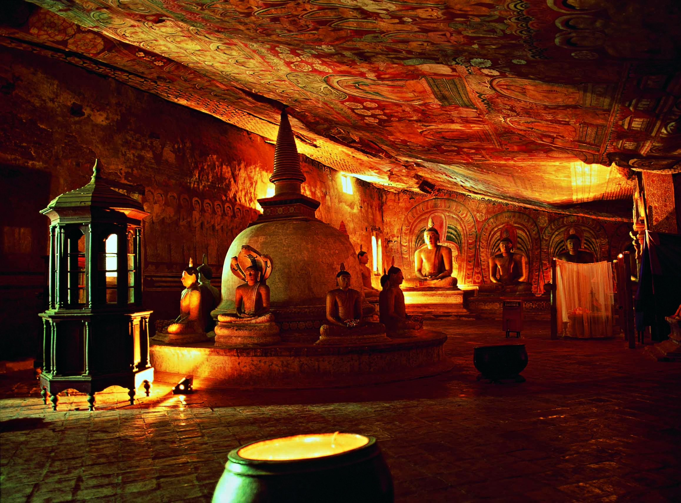 Buddhist statues walls covered in painted murals