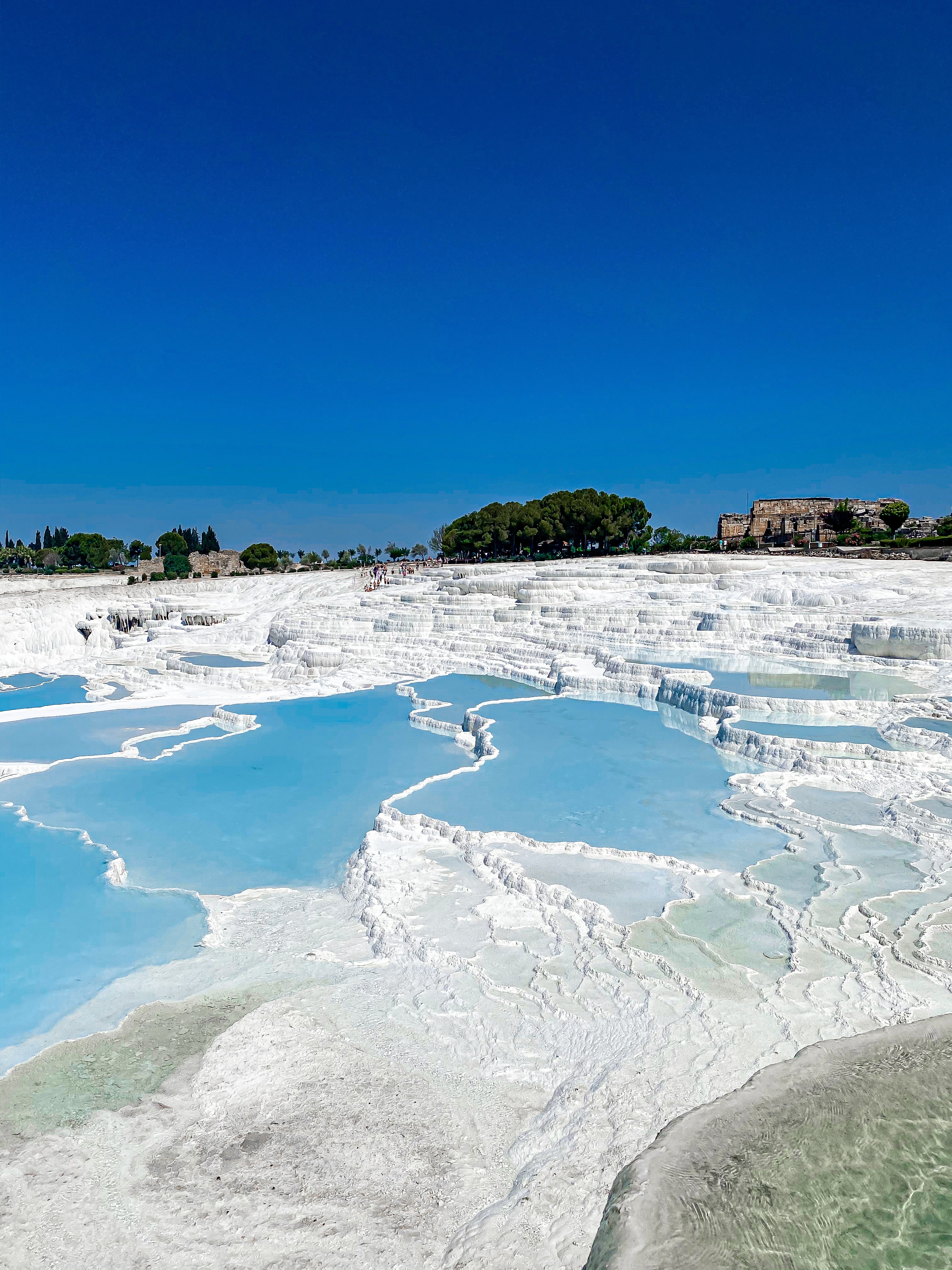 A picture of thermal pools with white terraces  