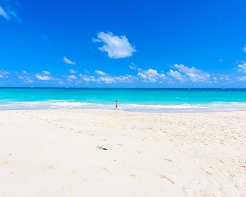 Man walking along a deserted tropical beach