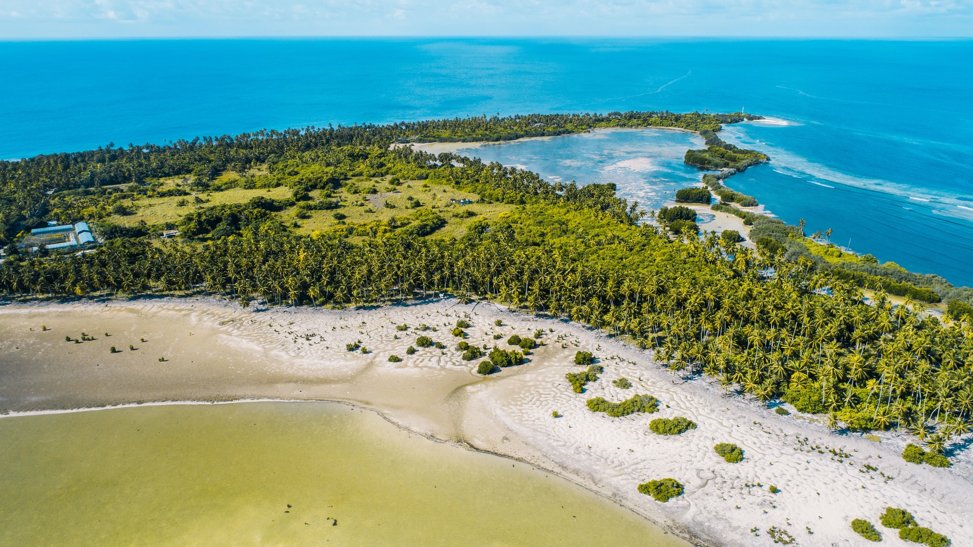 Narrow island with white sand beaches and palm tree forests