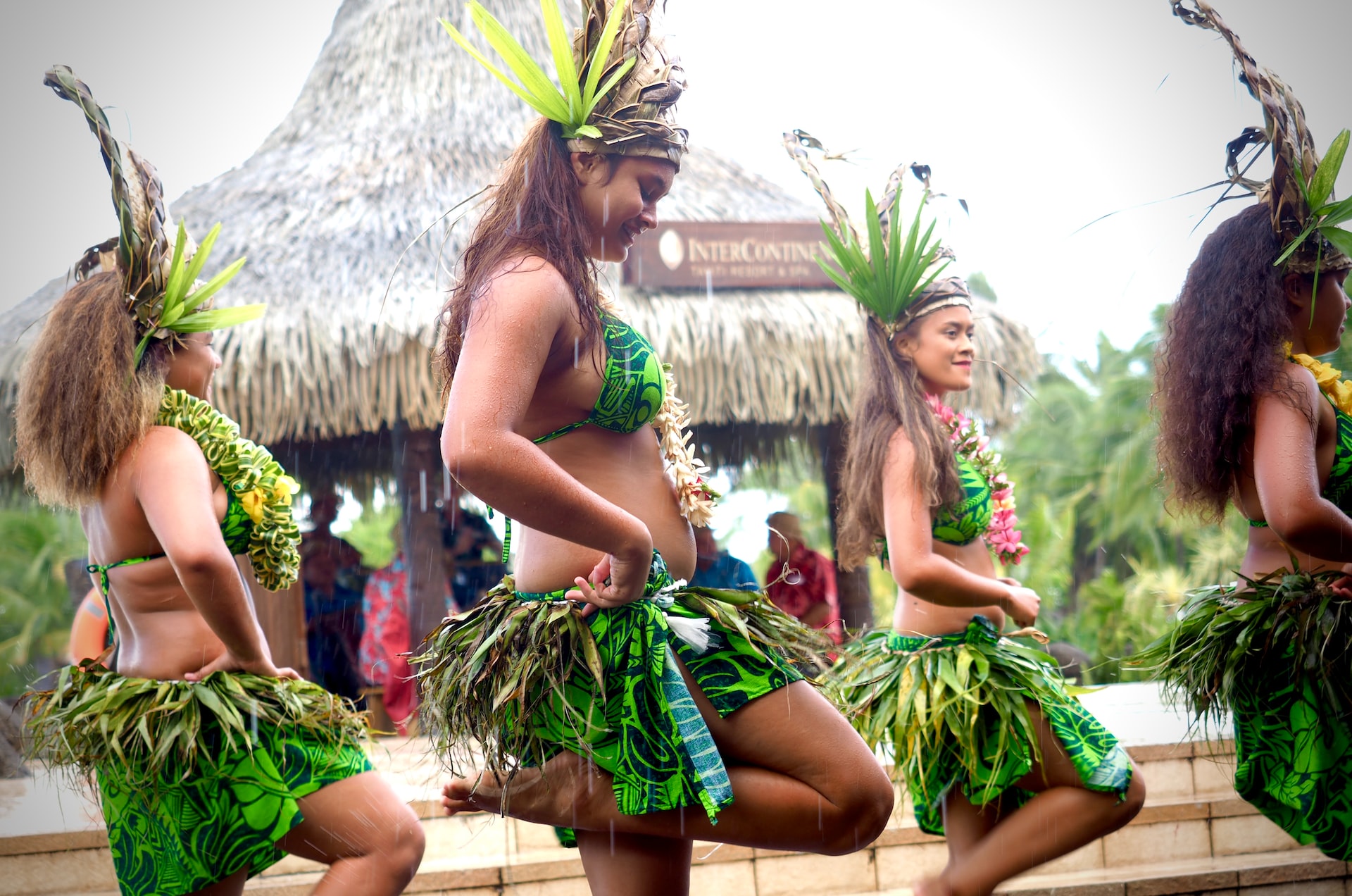 Four women hula dancers in traditional costumes