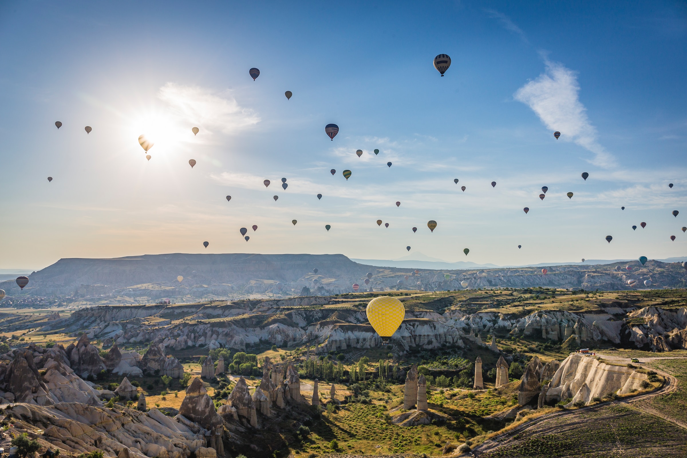 Hot air balloons in the clear blue sky over beautiful landscapes