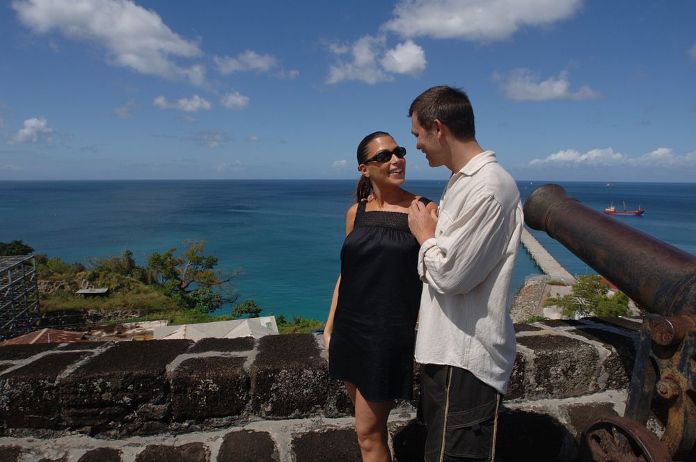 A couple standing by a small wall at Fort George in Grenada