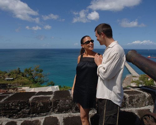 A couple standing by a small wall at Fort George in Grenada