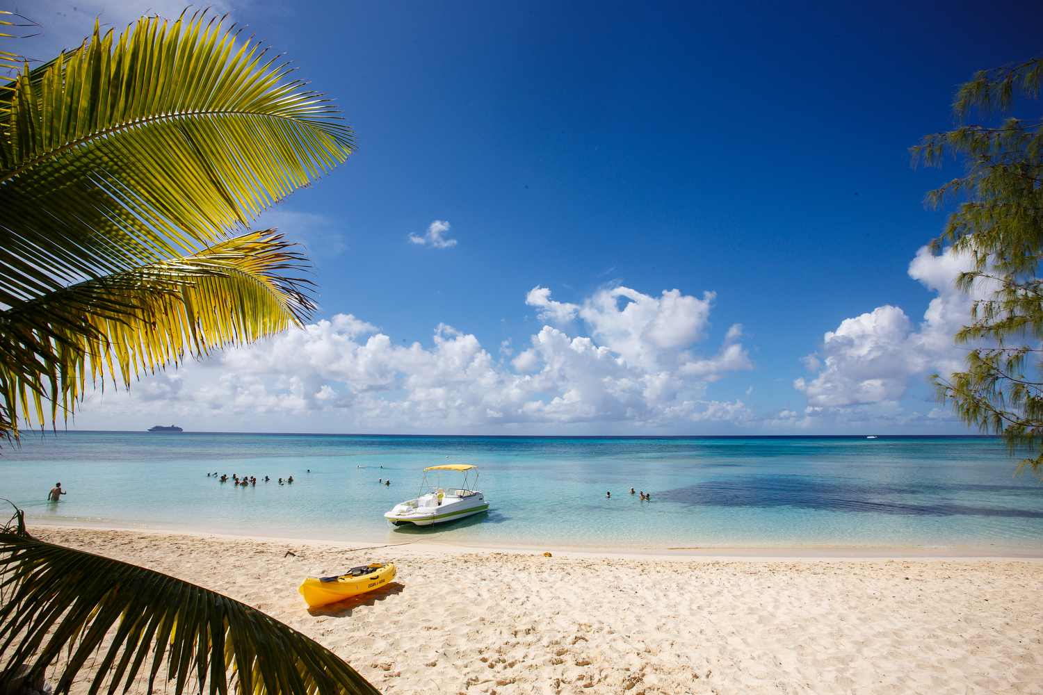 Small boat moored on a white sand beach 