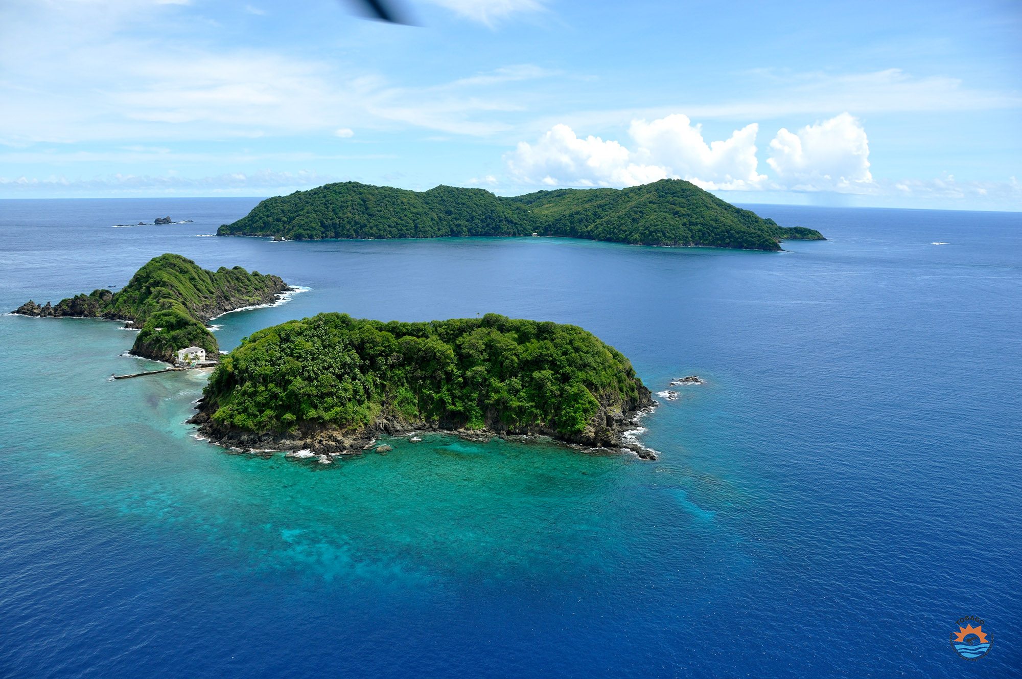 Aerial view of several small hilly islands surround by clear blue water