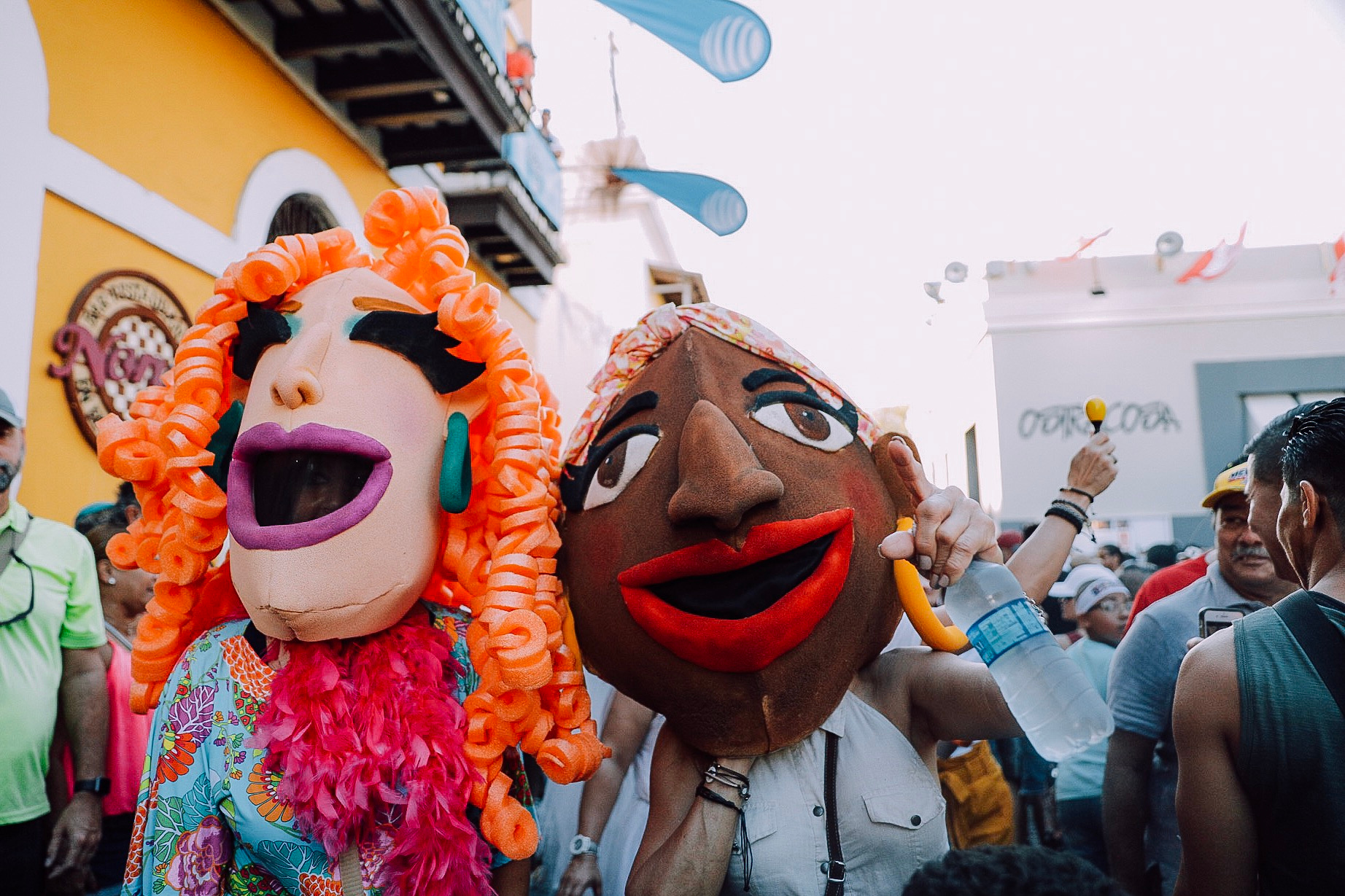  Two people at a Carnival wearing festival large masks 