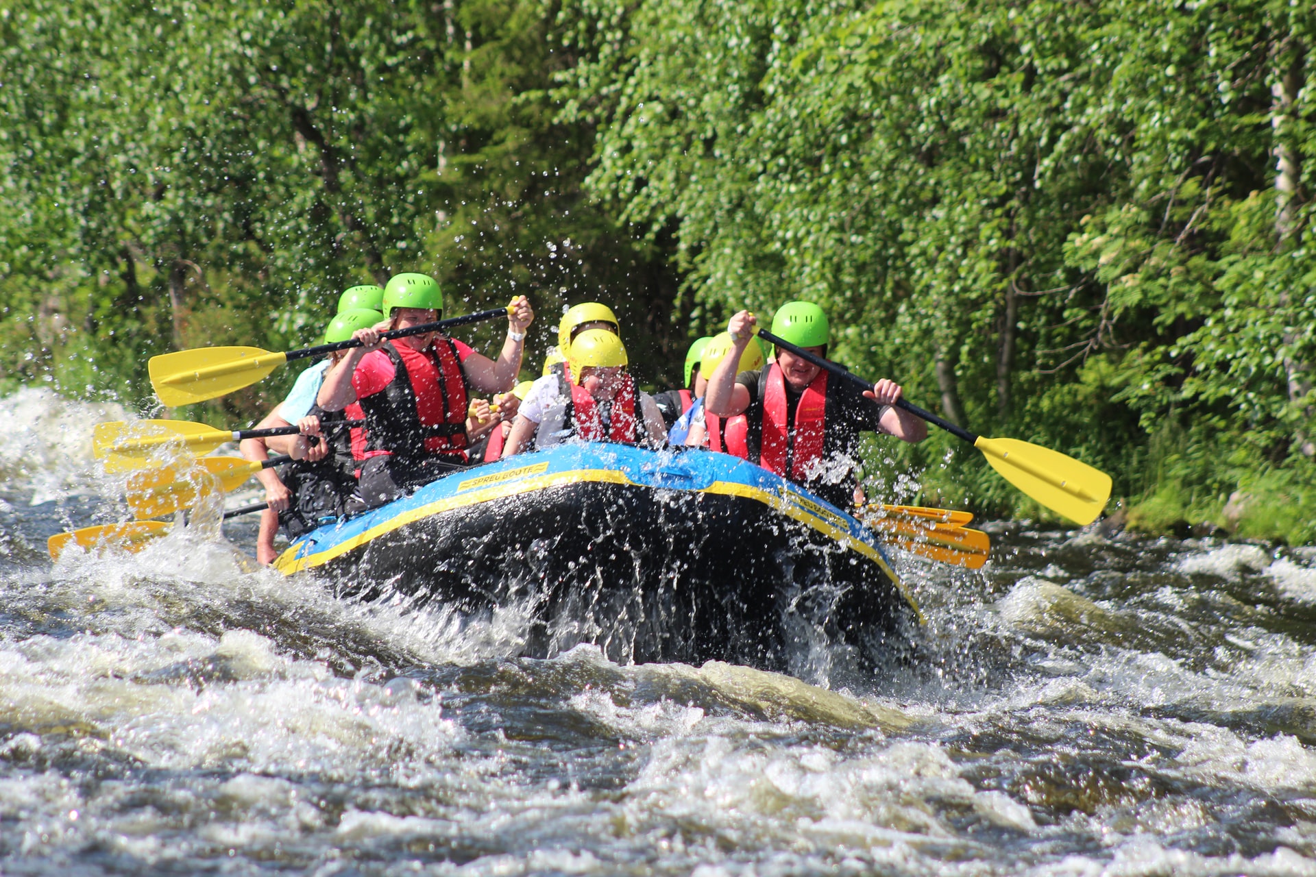Group of people river rafting on a sunny day 