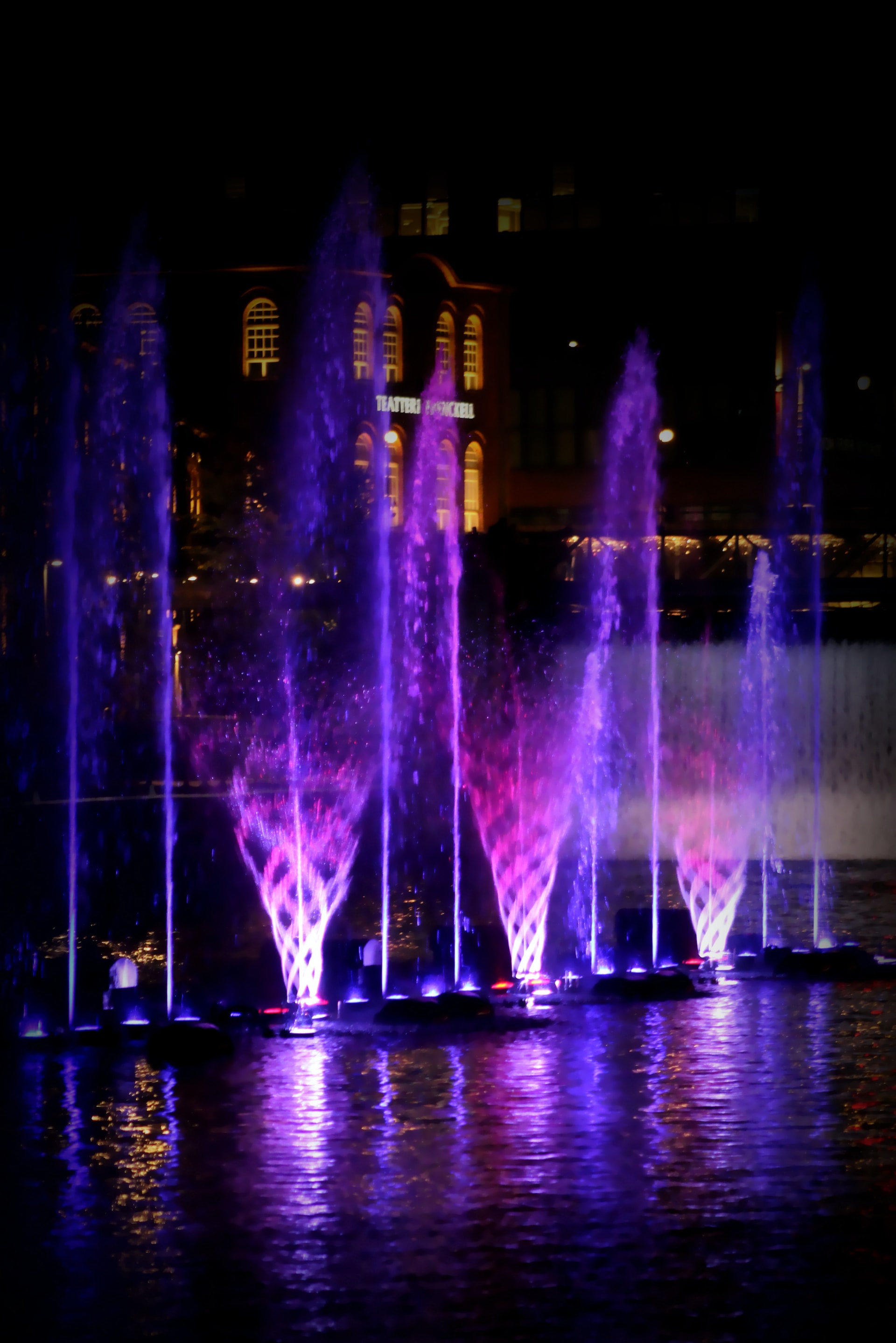 Fountain show with purple lights