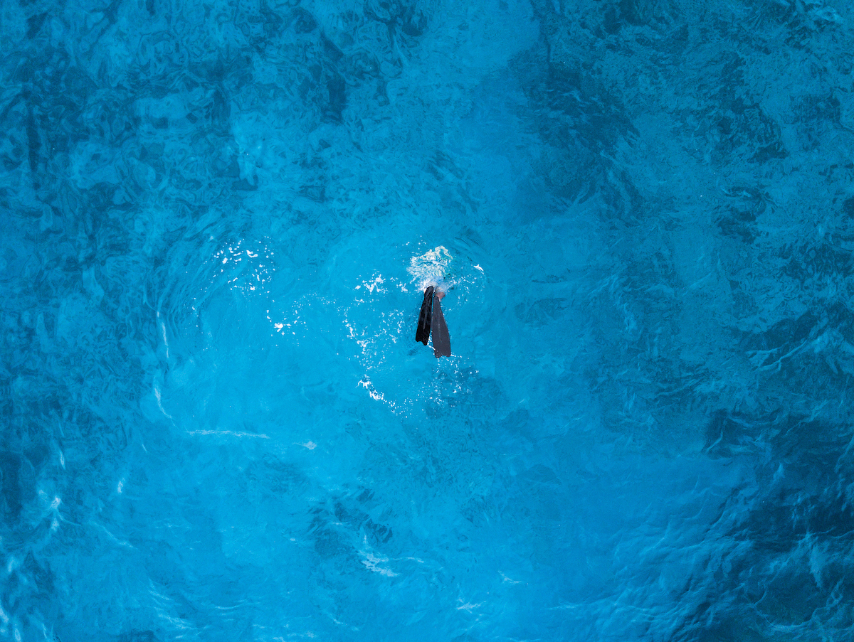 Scuba diving in middle of crystal blue ocean