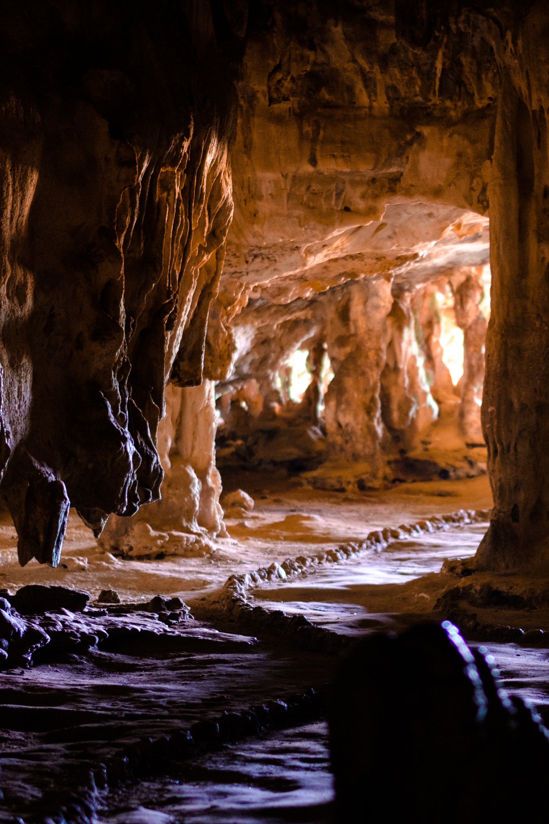 Brown rock formations in a dark cave