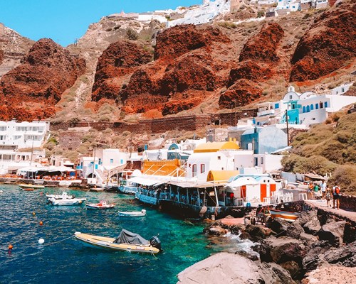 Tavernas and beach facilities sat at the foot of red-hued clifs