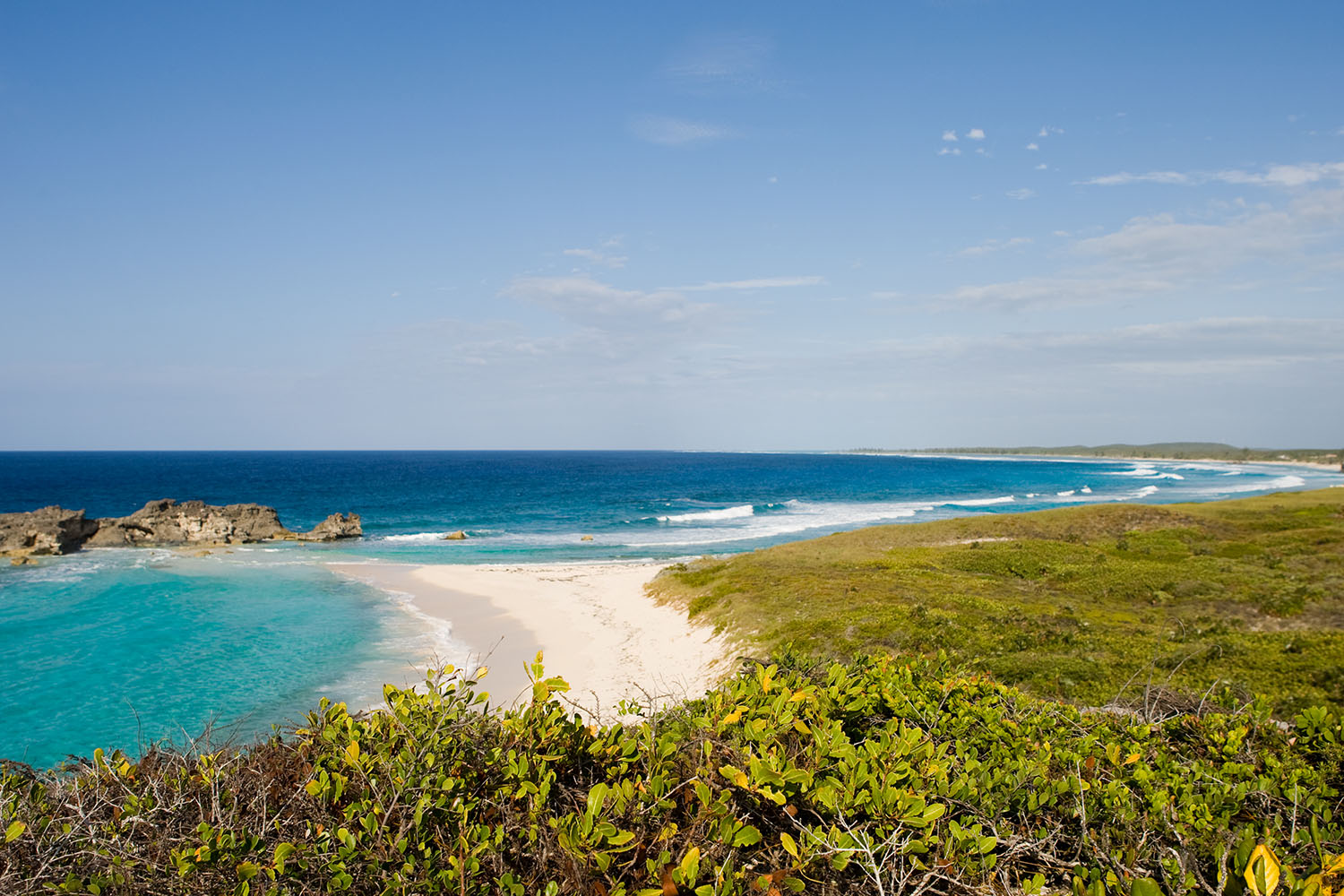 Waves crashing on a white sand tropical beach