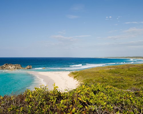 Waves crashing on a white sand tropical beach