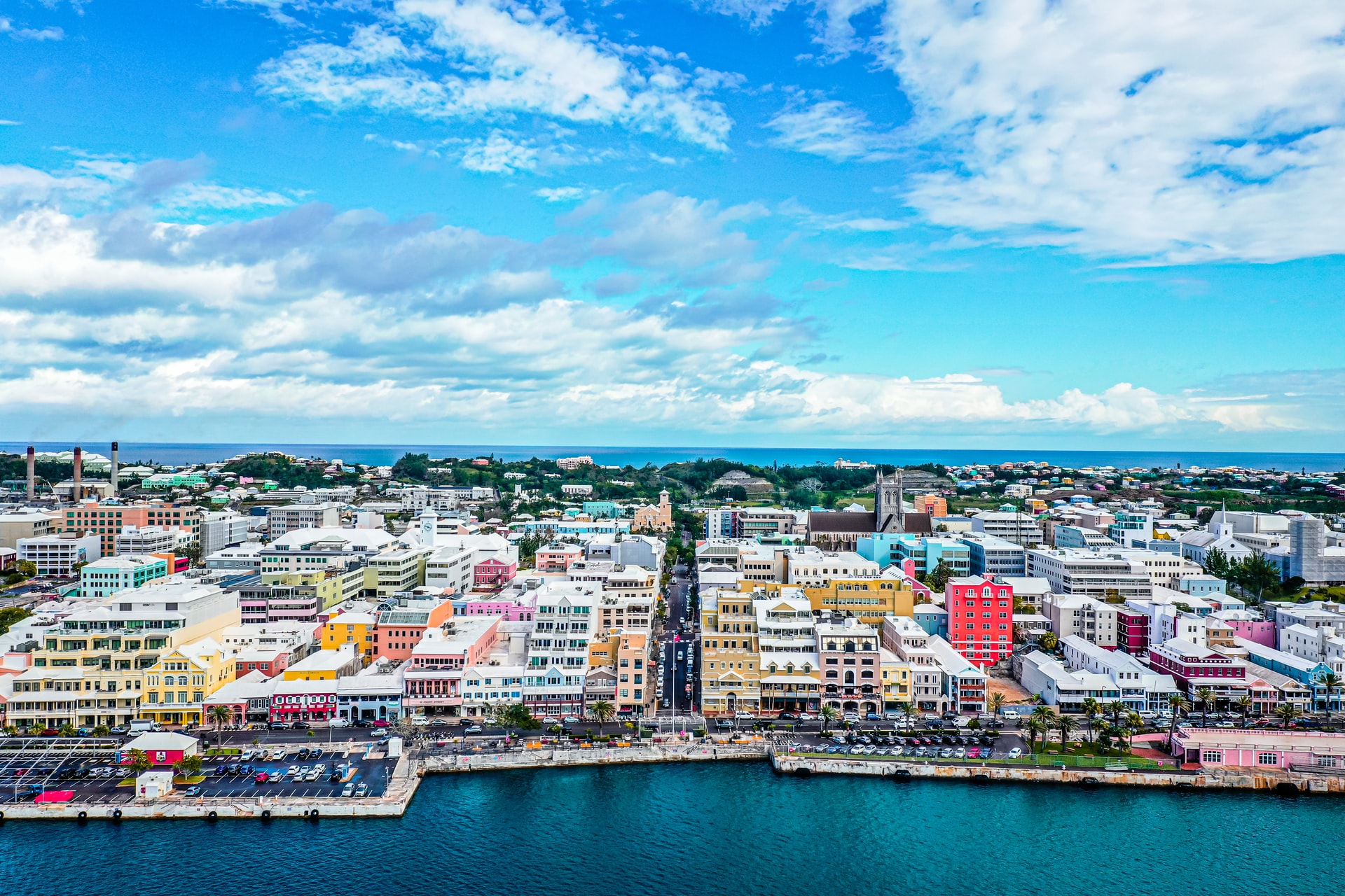 Aerial view of an island edge of a town with colourful buildings 