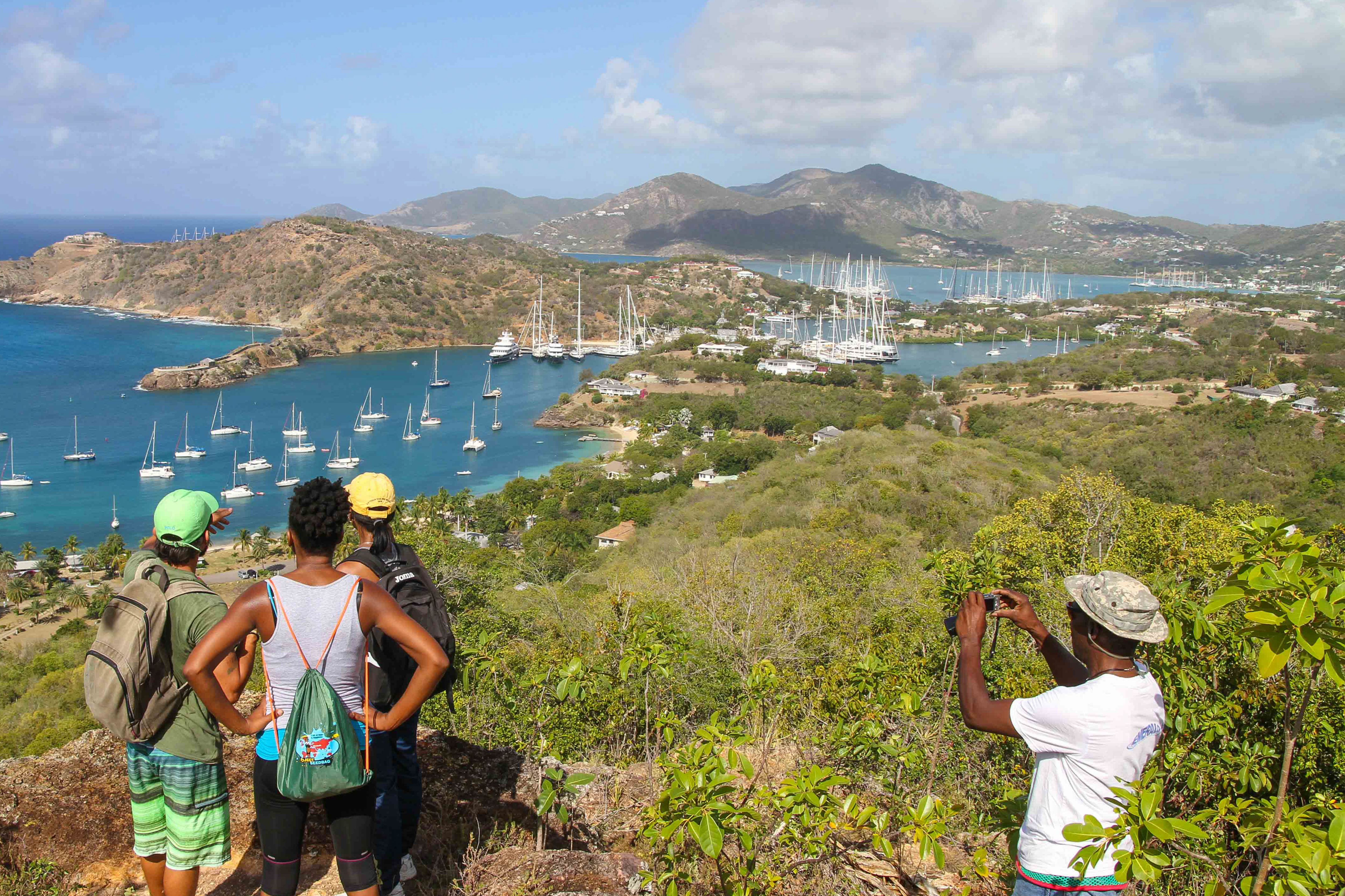 Group on top of hill hiking at English Harbour in Antigua