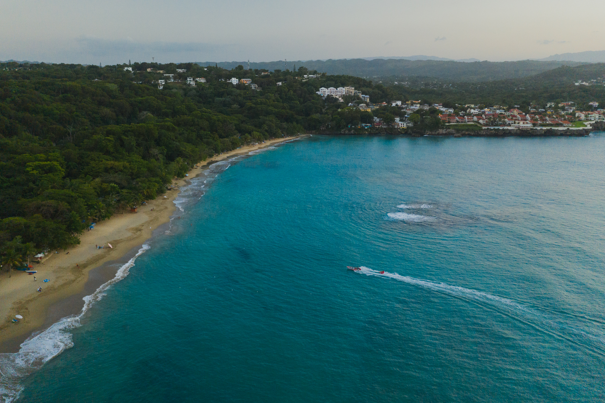 Aerial view of  a tropical beach with golden sand and bright blue sea