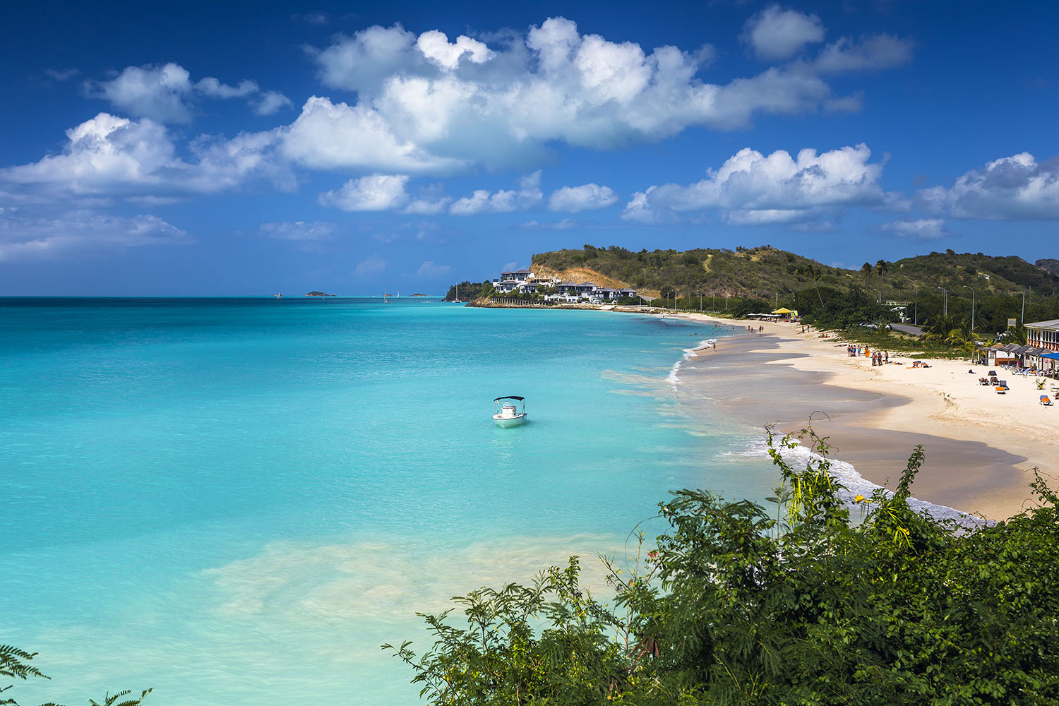 Tropical beach at Antigua with white sand, turquoise sea and blue sky
