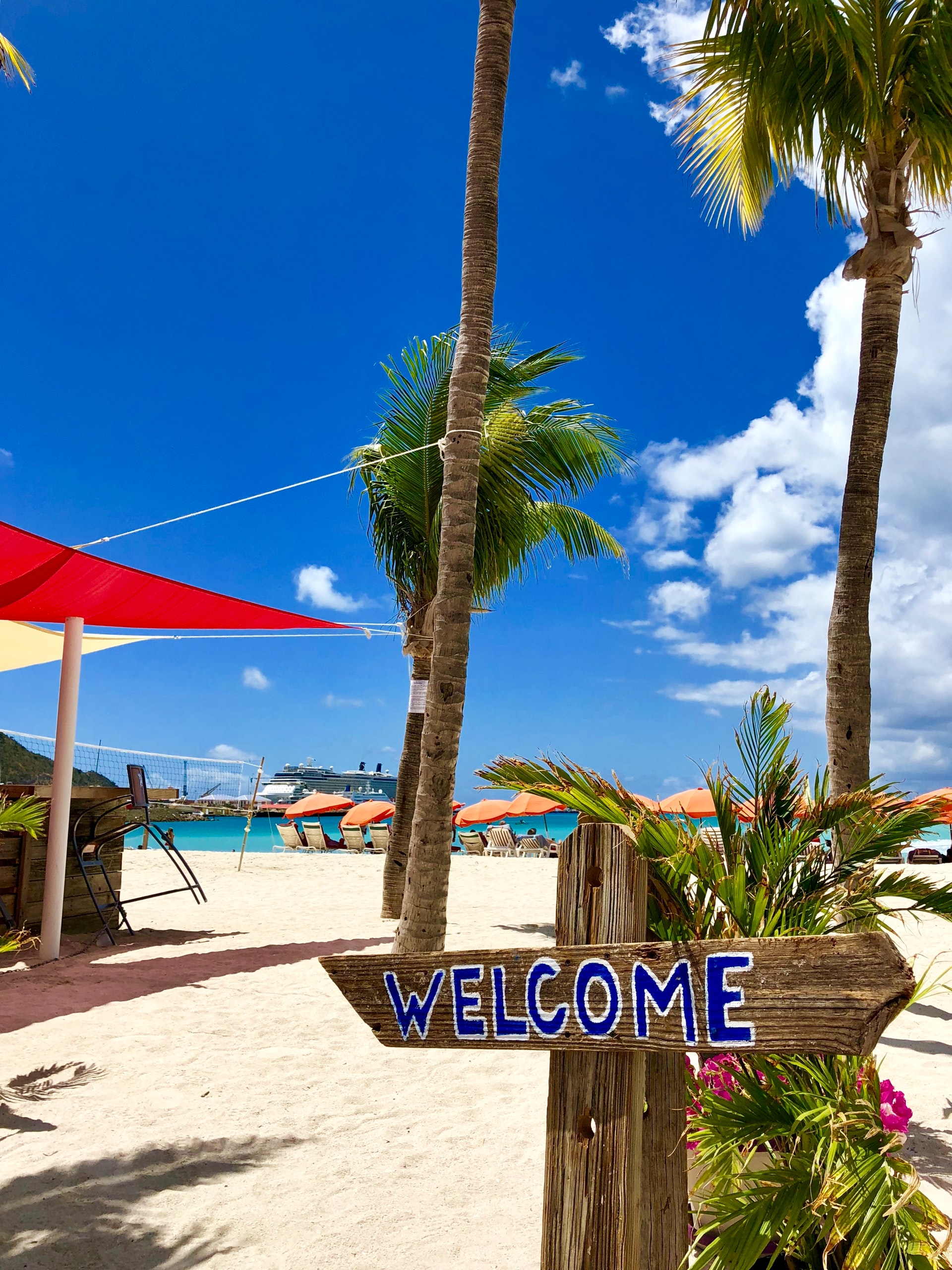 Welcome Sign On Beach Cruise Ship In Background