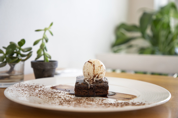 Chocolate brownie with vanilla ice cream on a plate