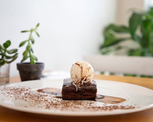 Chocolate brownie with vanilla ice cream on a plate