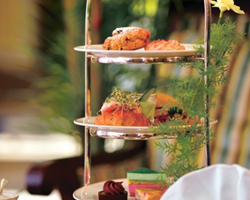 Afternoon sandwiches and cakes with a cup of tea